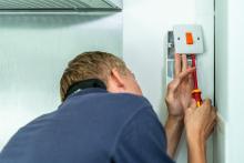 Image of an electrician testing a socket