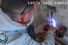 Image of an electrician installing a plug socket during a rewire