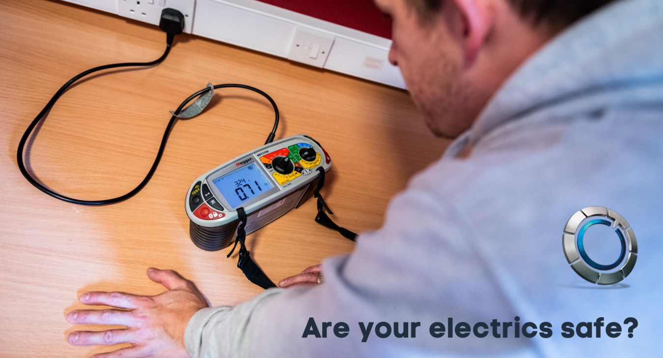 Image of electrician using electrical testing equipment on a plug socket