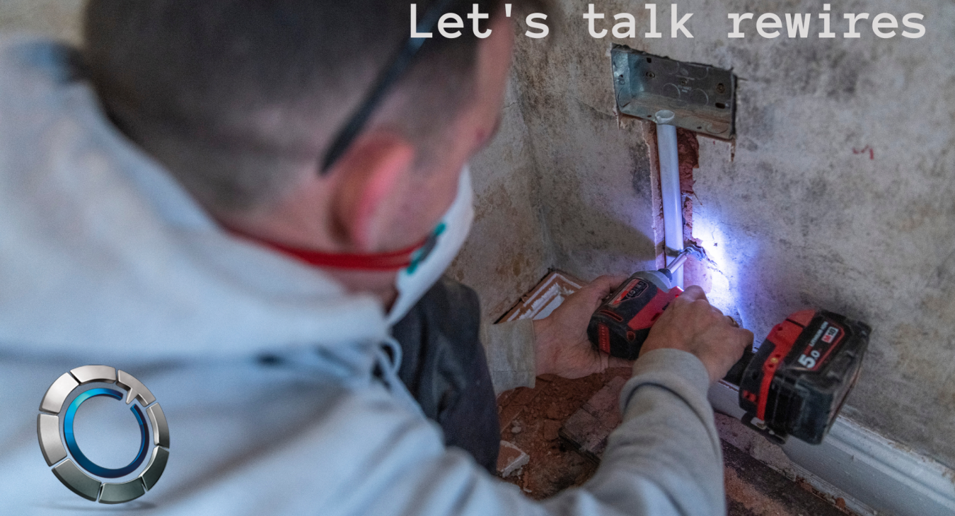 Image of an electrician installing a plug socket during a rewire