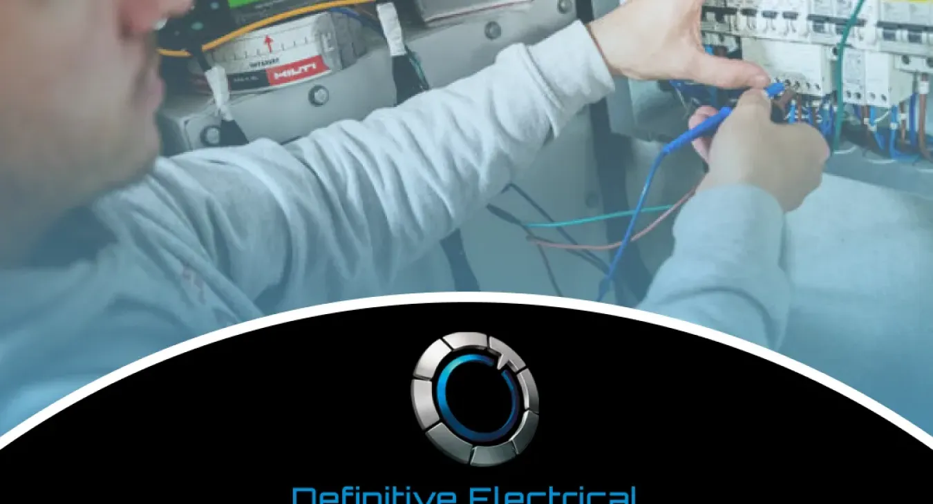 Electrician working on a control panel with wires and tools.